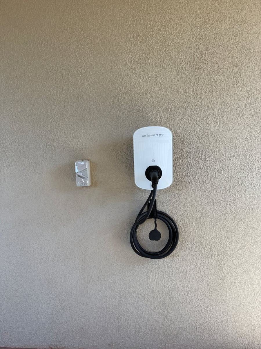 Wall-mounted EV charger installed on a rendered wall