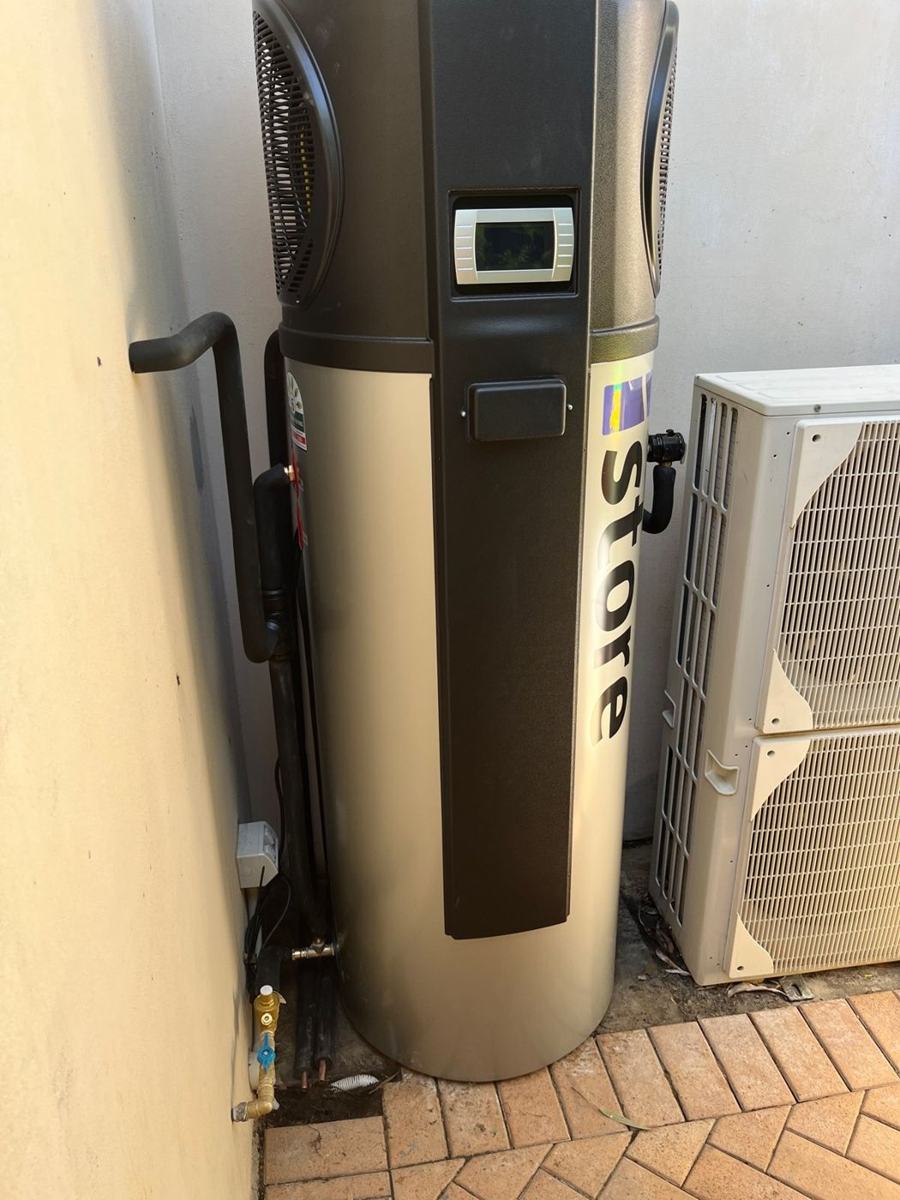 iStore heat pump hot water unit installed on a side path