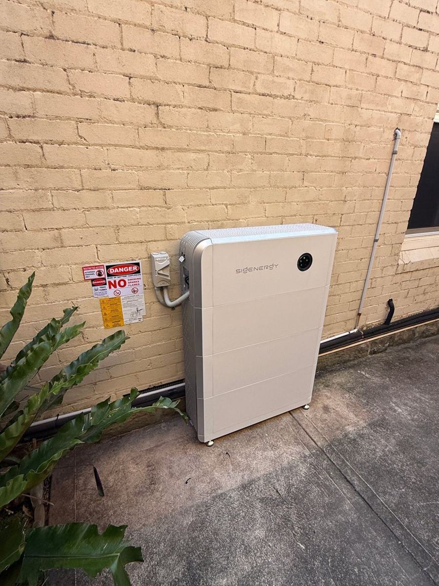 Sigenergy SigenStor home battery installed against a brick wall by Infinite Electrical & Solar