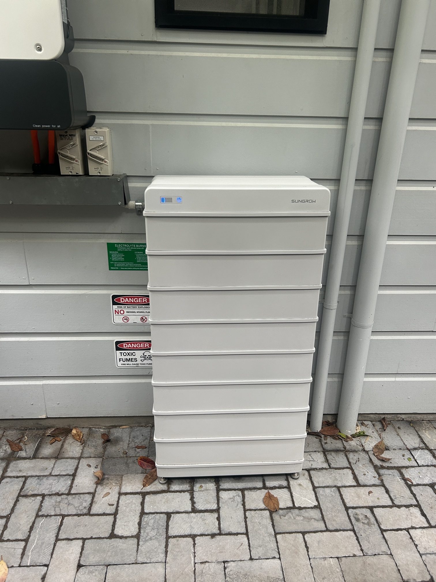 Sungrow inverter and battery stack installed on an exterior wall