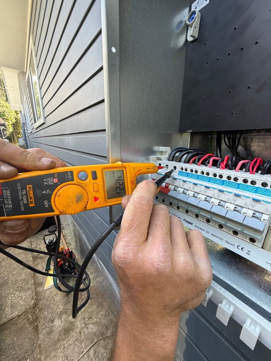Electrician testing circuits on a new switchboard